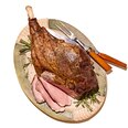 Roasted leg of lamb, sliced and served on a platter with rosemary garnish, ready-to-serve entrée.
