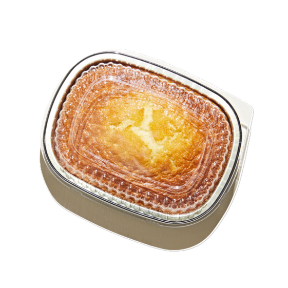Golden cornbread in a ready-to-heat bakery container, freshly baked side dish with a crisp, buttery top.