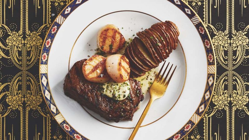 GRILLED STEAK AND SCALLOPS WITH HERB BUTTER AND HASSELBACK POTATOES